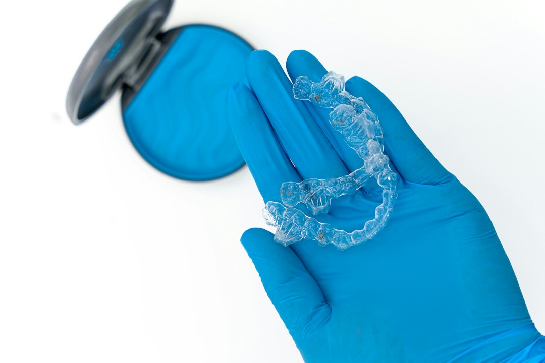Clear appliance held in a gloved hand