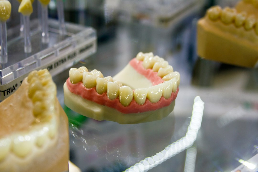 Finished denture and models on the quality control bench