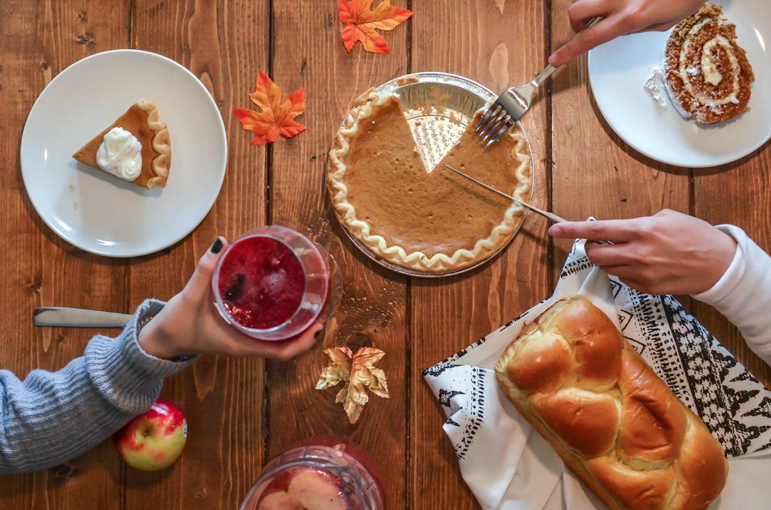 Pumpkin pie and autumn leaves on a wooden table